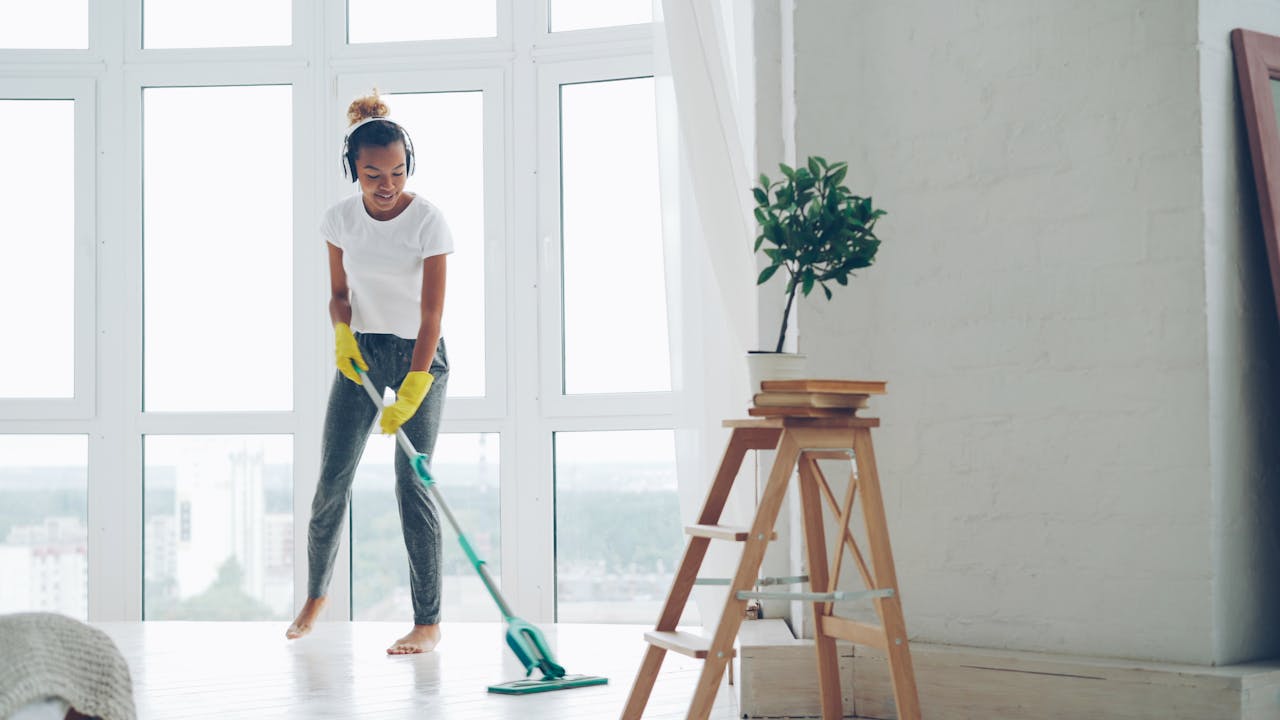woman-mopping-floor-in-bright-modern-room-36729576